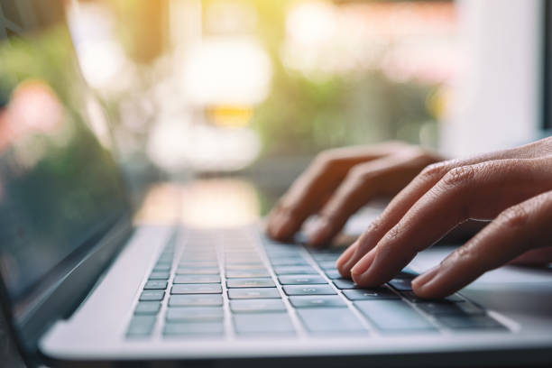 istock a woman working and typing on laptop computer keyboard 1182576324