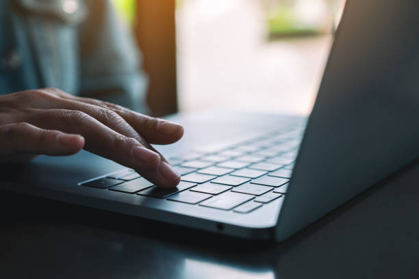 istock a woman typing and pressing finger on laptop computer keyboard 1182577308