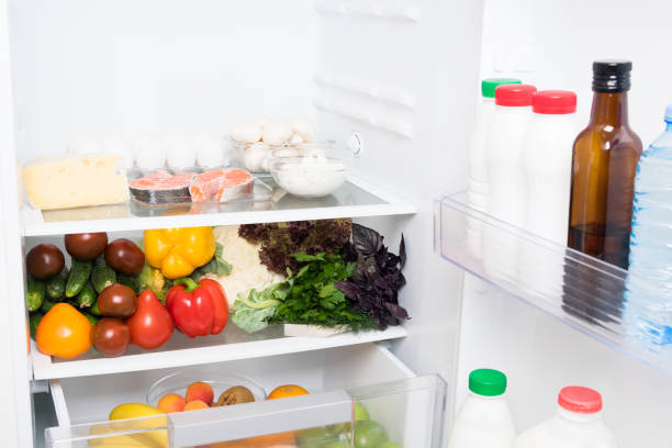 istock open fridge with vegetables and dairy products inside 1182582934