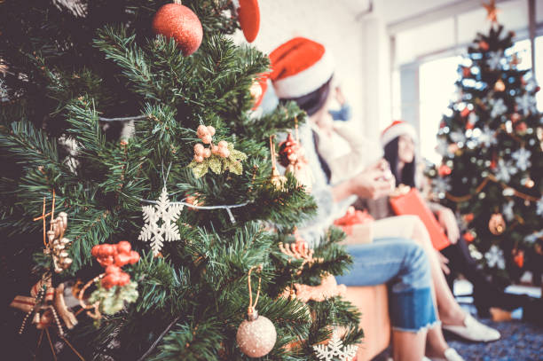 istock Selective focus Decorate christmas tree and background blurred asian people party celebrate new year eve in house 1182584122