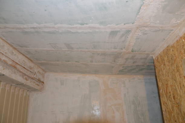 istock Wall painting in the interior with white water-based paint 1182584925