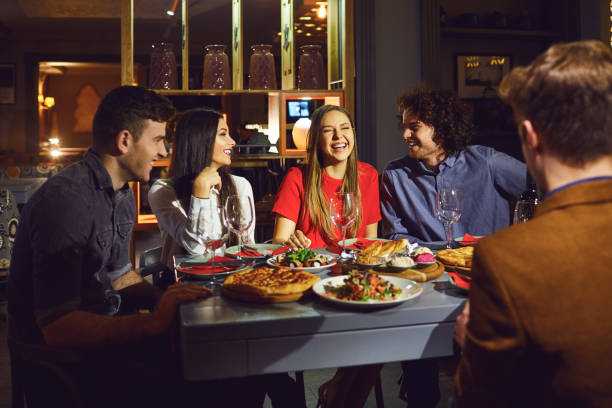 istock A group of friends eating at a dinner in a restaurant. 1182585400