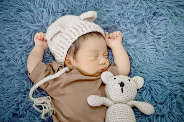 istock Newborn baby sleeping on a blanket grey 1182585425