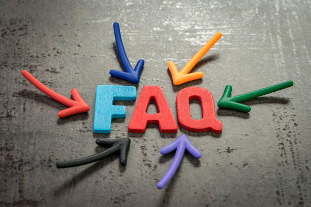 istock FAQ, Frequently asked question, all important question and answer that easy to understand concept, multi color arrows pointing to the word FAQ at the center of black cement chalkboard wall 1182586275