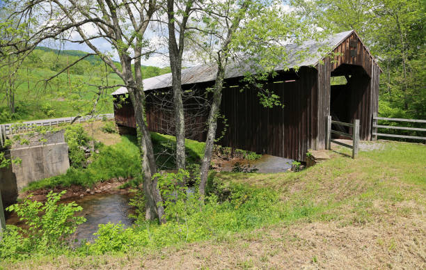 istock Locust Creek covered bridge behind trees 1182586450