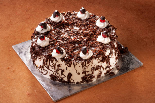 istock Black forest cake decorated with whipped cream and cherries. 1182587314