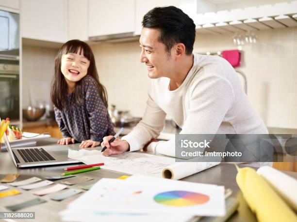 Asian Father Working From Home While Caring For Daughter Stock Photo - Download Image Now