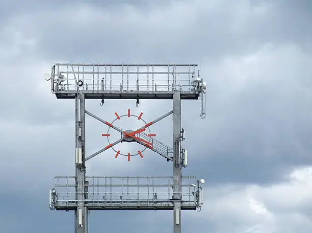 a big clock at a racetrack in Southern Germany named "Hockenheimring" in front of clouded sky
