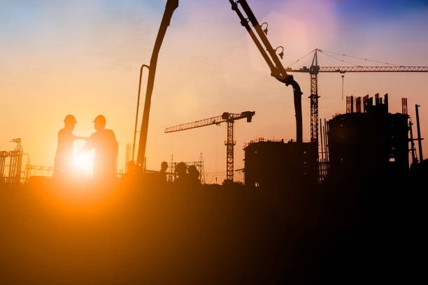 istock Silhouette of engineer and construction team working at site over blurred background for industry background with Light fair.Create from multiple reference images together 1182593762