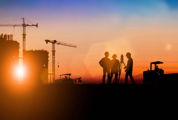 istock Silhouette of Survey Engineer and construction team working at site over blurred  industry background with Light fair.Create from multiple reference images together 1182593763