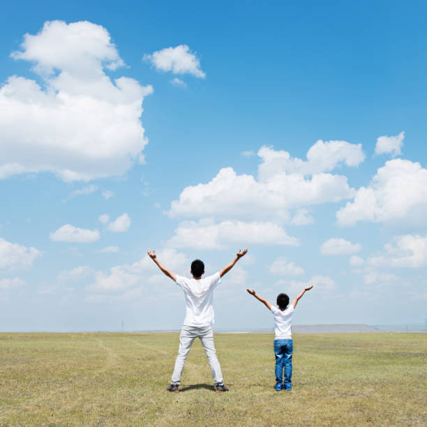 istock Father and son arms outstretched 1182594099