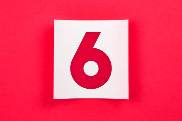 Top View White Number 6 Post It Note Paper On Red Background. With Natural Shadow