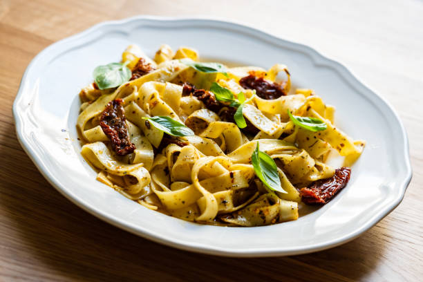 istock Tagliatelle with olive and parmesan on timber background 1182596838