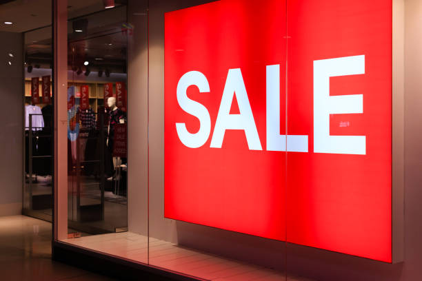 istock Window display with red sale board in night view 1182598040