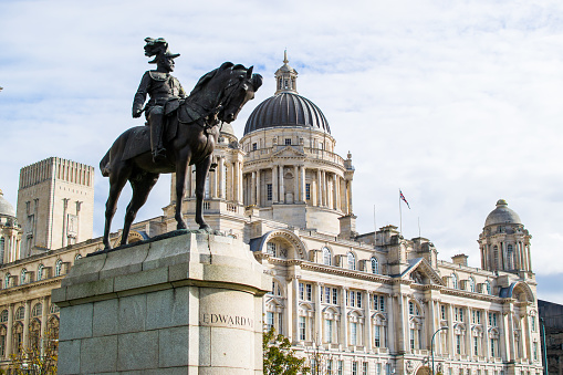 Monument to King Edward VII at the foreground with Port of Liverpool Building (or Dock Office) at the background, in Pier Head, along the Liverpool's waterfront, England, United Kingdom