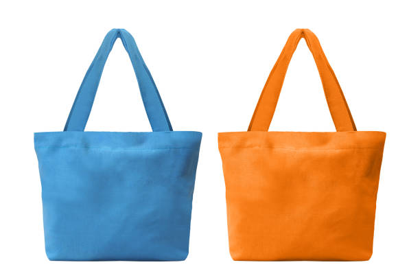 blaue und orange tuch einkaufstasche isoliert auf weißem hintergrund mit clipping-pfad - shopping bag orange bag handle stock-fotos und bilder