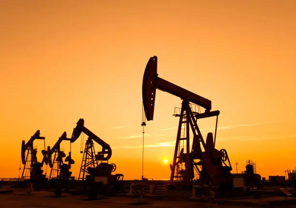 Oil pumps and rig at sunset