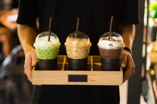 Photo of Men holding Beverage drinks ready to serve,cafe style,green tea ,coffee,chocolate