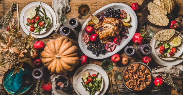 istock Thanksgiving party table setting with roasted chicken seasonal produce 1182601896
