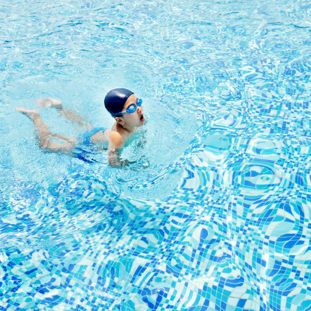 istock Little boy swimming in pool 1182602984