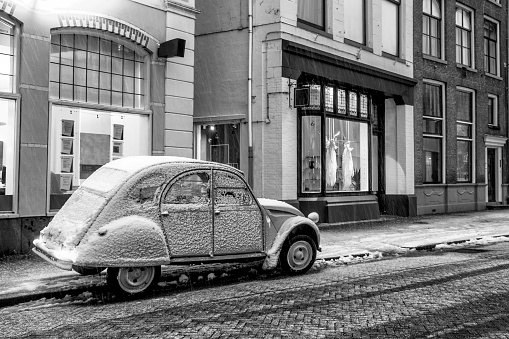 Classic French 2CV car parked on the side of the street during winter in the city of Zwolle, The Netherlands.