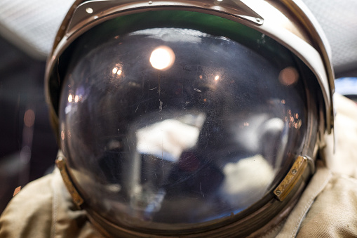 Closeup of a very old spaceman helmet with reflections. Outer space and exploring.