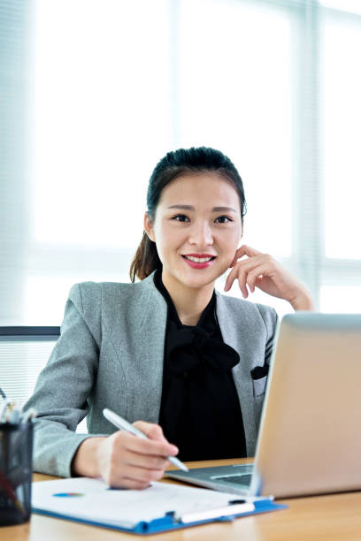 istock Beautiful businesswoman using laptop 1182605957