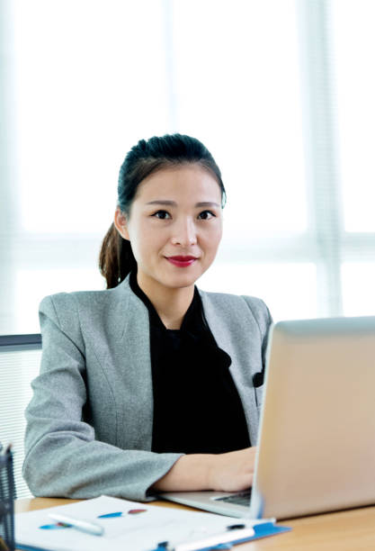 istock Beautiful businesswoman using laptop 1182605959