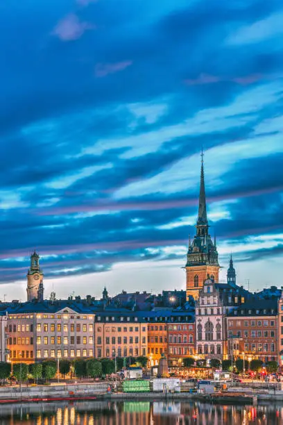 Photo of Stockholm, Sweden. Scenic View Of Skyline At Evening Night. Tower Of Storkyrkan - The Great Church Or Church Of St. Nicholas And German St Gertrude's Church. Famous Popular Destination In Night