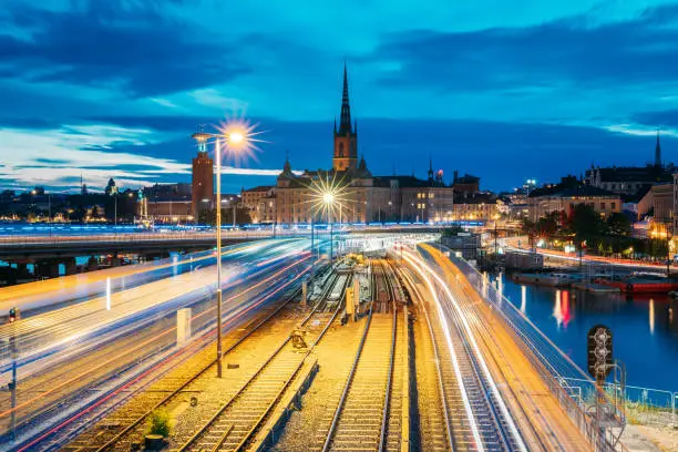 Photo of Stockholm, Sweden. Scenic View Of Stockholm Skyline At Summer Evening. Famous Popular Destination Scenic Place. Riddarholm Church And Subway Railway