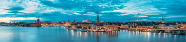 Stockholm, Sweden. Scenic View Of Stockholm Skyline At Summer Evening. Famous Popular Destination Place In Dusk Lights. Riddarholm Church In Night Lighting. Panorama Panoramic View Stockholm, Sweden. Scenic View Of Stockholm Skyline At Summer Evening. Famous Popular Destination Scenic Place In Dusk Lights. Riddarholm Church In Night Lighting. Panorama Panoramic View. kungsholmen town hall photos stock pictures, royalty-free photos & images