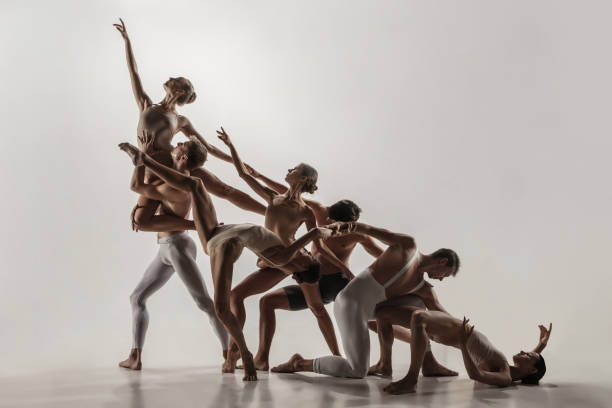 the group of modern ballet dancers. contemporary art ballet. young flexible athletic men and women. - dancer jumping ballet dancer ballet imagens e fotografias de stock