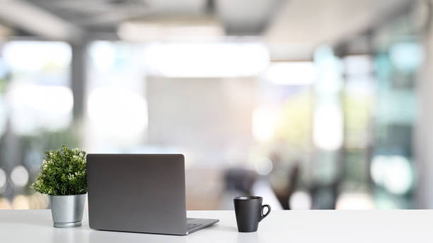 istock Workspace laptop computer and coffee cup with plant pot on office table. 1182608819