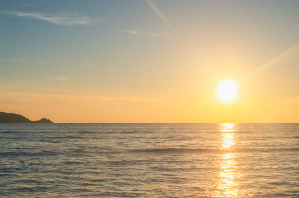 istock Tropical beach with smooth wave and sunset sky abstract background. 1182608831
