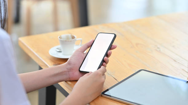 istock Close-up woman doctor holding het smartphone mockup empty screen. 1182610351