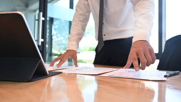 Businessman analysis and review document finance data.