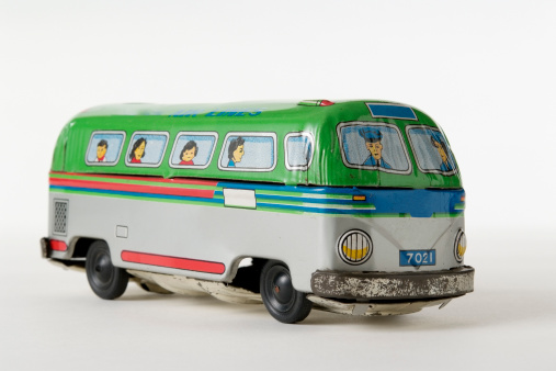 Old tin toy air lines bus isolated on white background.