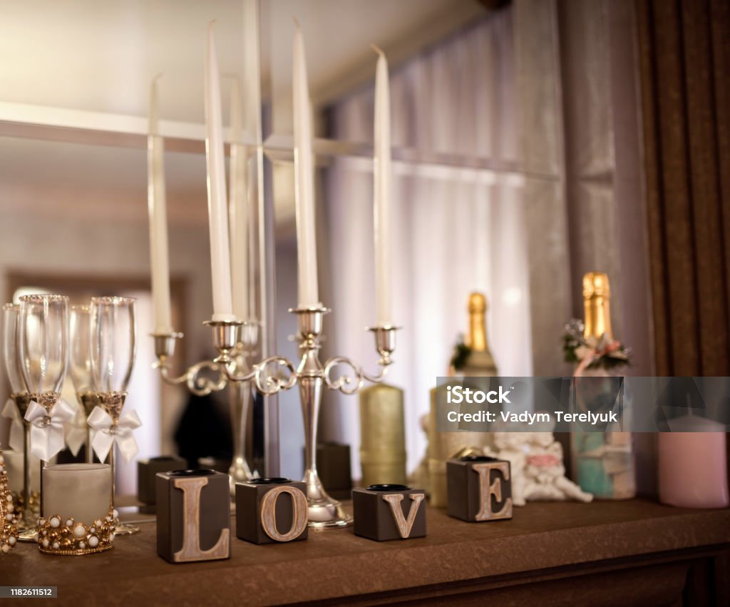 Wedding Decoration. Wedding Decoration. Candleholder and wooden love letters in the mirrow reflection background. Closeup. Architectural Column Stock Photo