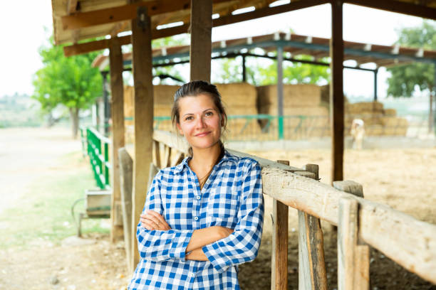 istock Happy woman near stable 1182614196