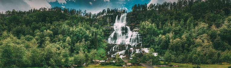 Voss, Hordaland, Norway. Waterfall Tvindefossen In Spring. Largest And Highest Waterfall Of Norway. Famous Natural Norwegian Landmark And Popular Destination. Panorama, Panoramic View.