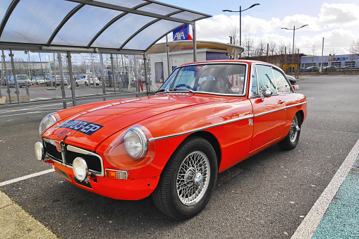Saint-Maximin, France - March 10 2019: The MGB is a two-door sports car manufactured and marketed by the British Motor Corporation (BMC), later the Austin-Morris division of British Leyland, as a four-cylinder, soft-top roadster in 1963 and the fixed-roof MGB GT was introduced in October 1965.