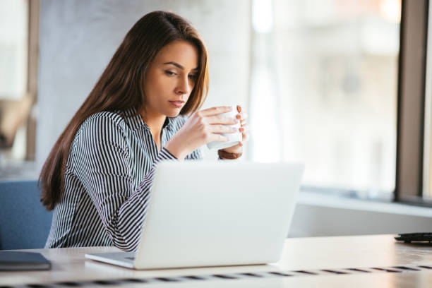 istock Beautiful woman drinking her coffee 1182615213