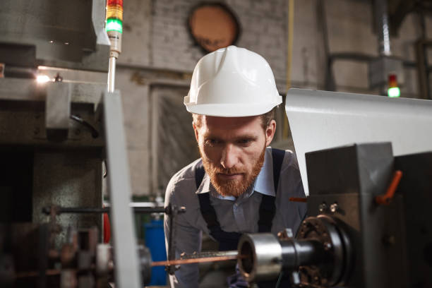 istock Mechanic looking at the work of machine 1182615938