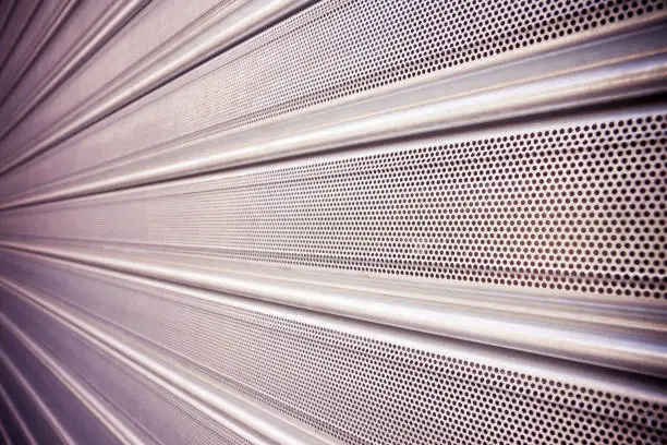 New closed metallic shutter door with perforated sheet.