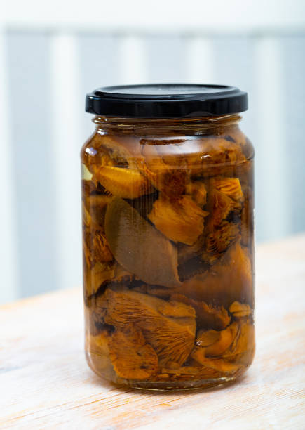 istock Closed glass jar with pickled lactarius deliciosus 1182616249