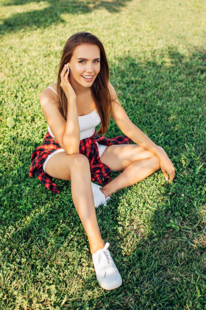 Beautiful woman sitting on the grass