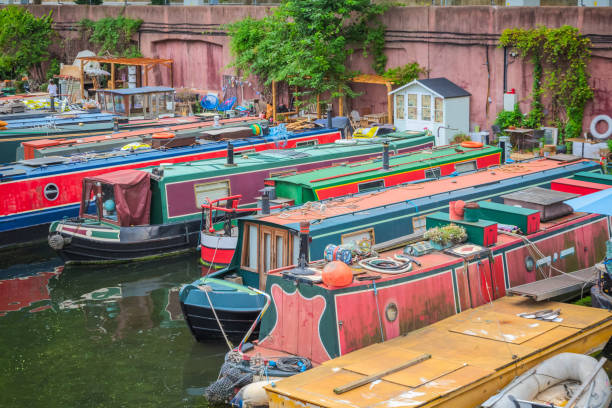 Narrow boats at Lisson Grove mooring site, part of Regent's Canal in London Row of narrow boats at Lisson Grove mooring site, part of Regent's Canal in London regents canal stock pictures, royalty-free photos & images