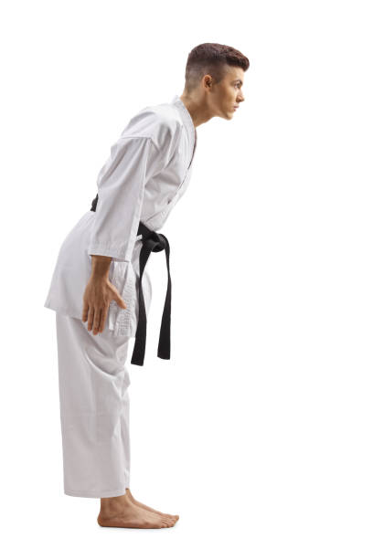 młody facet w karate kimono z czarnym pasem kłaniając się - respect karate bowing martial arts zdjęcia i obrazy z banku zdjęć
