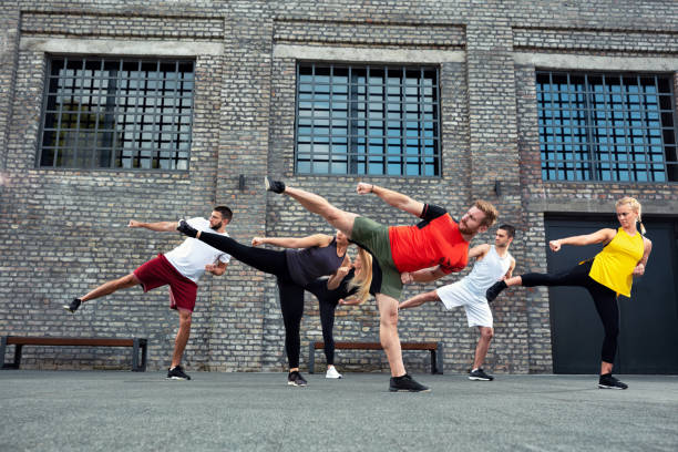 istock Coach teaching his group if trainees about leg kicks 1182618031