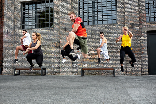 Athletes jumping during a workout session, group exercise